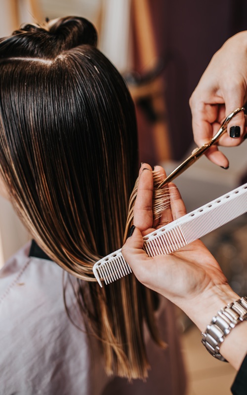 This woman gets a haircut from our professionals at Lemon Tree - a top franchise opportunity near you.