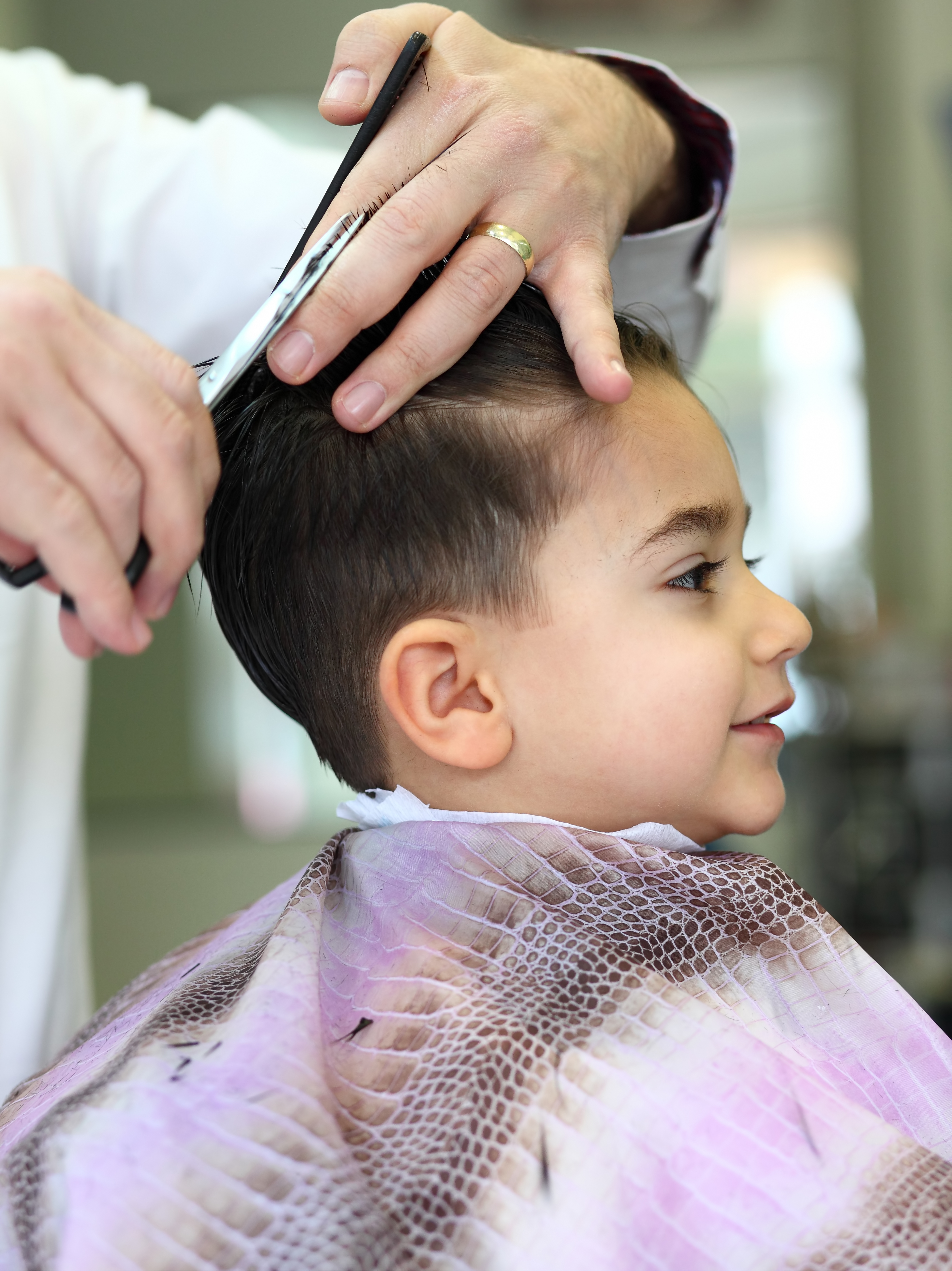 A little boy getting a kids haircut from Lemon Tree Hair Salons.