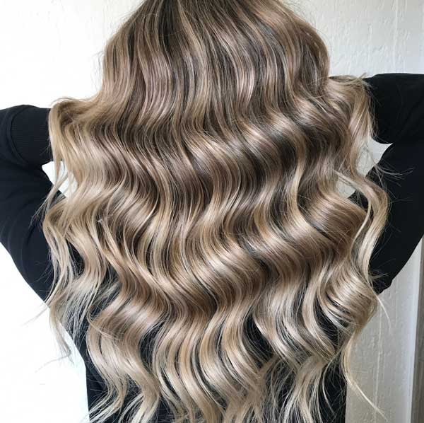 Woman with beautiful highlights suggests Lemon Tree Hair Salons for their quality coloring.