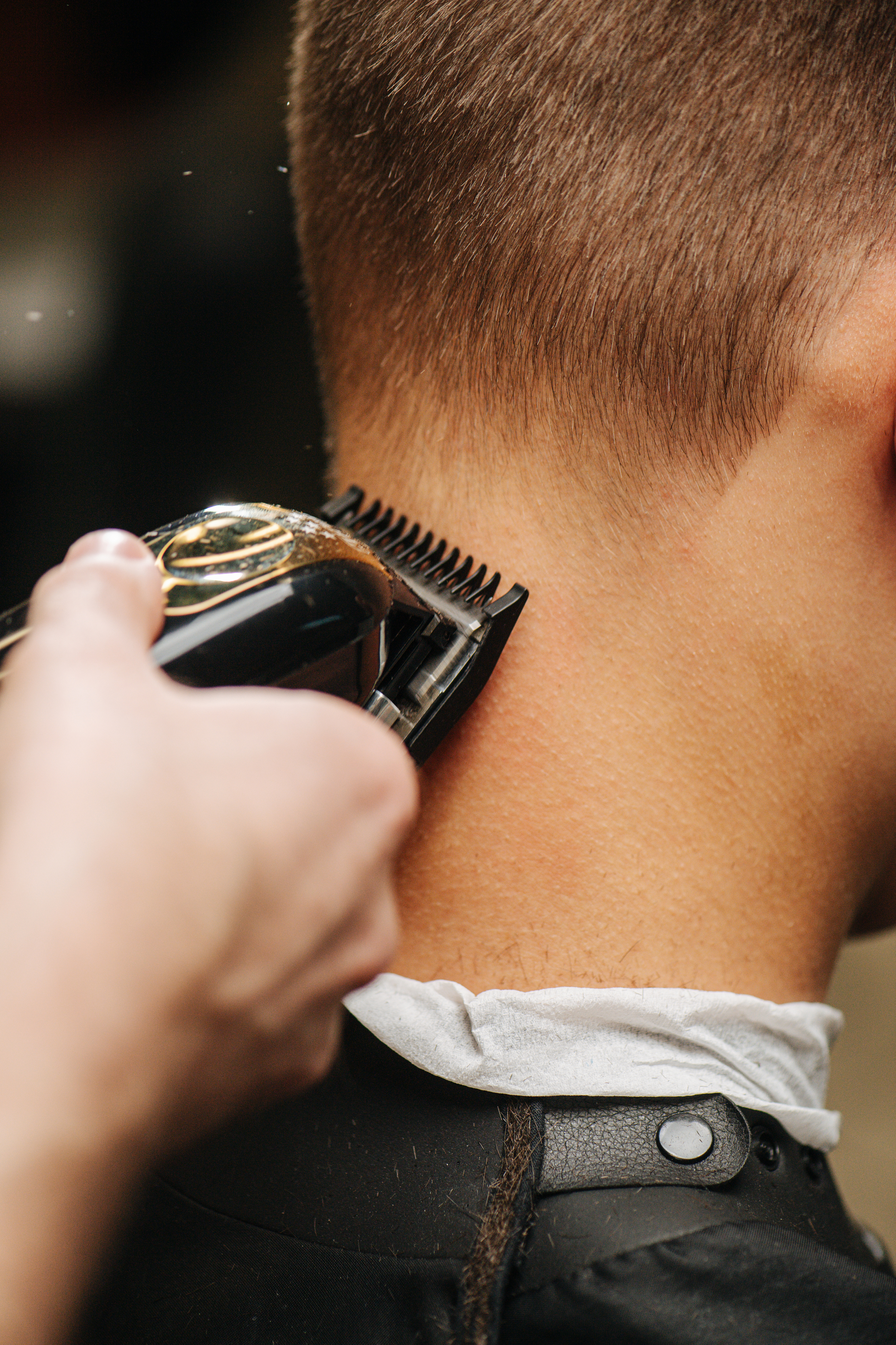  A man's neck getting shaved during a mens haircut with Lemon Tree.